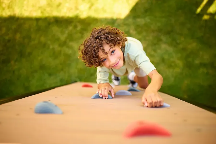 Child climbing on a BERG PlayBase frame